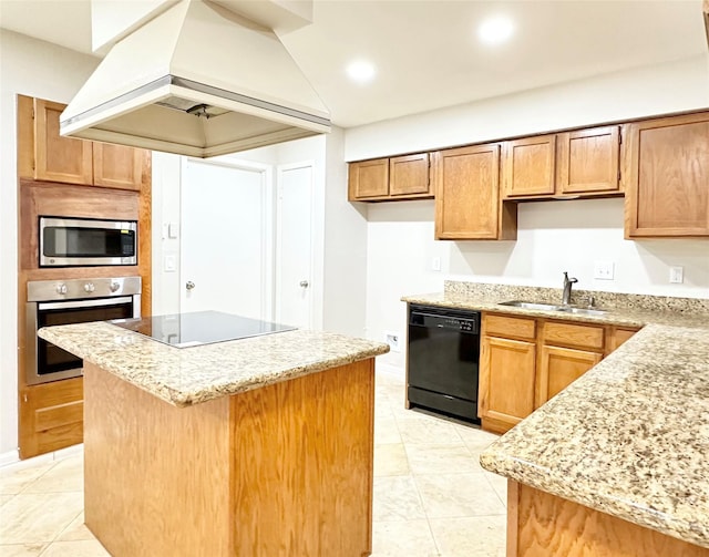 kitchen with a kitchen island, light stone countertops, custom exhaust hood, black appliances, and a sink