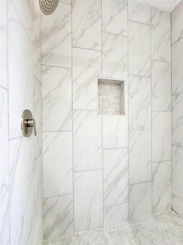 bathroom featuring tiled shower