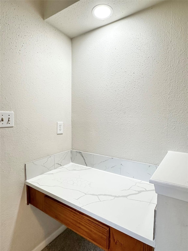 bathroom with a textured wall