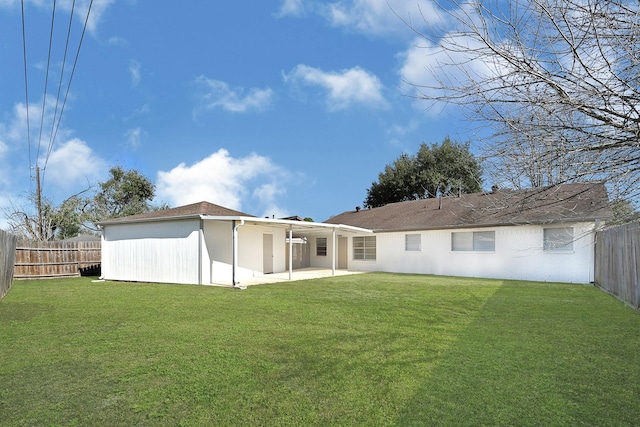 rear view of property with a patio area, a fenced backyard, and a lawn