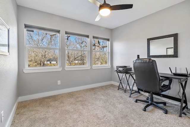 office space featuring carpet, a ceiling fan, and baseboards