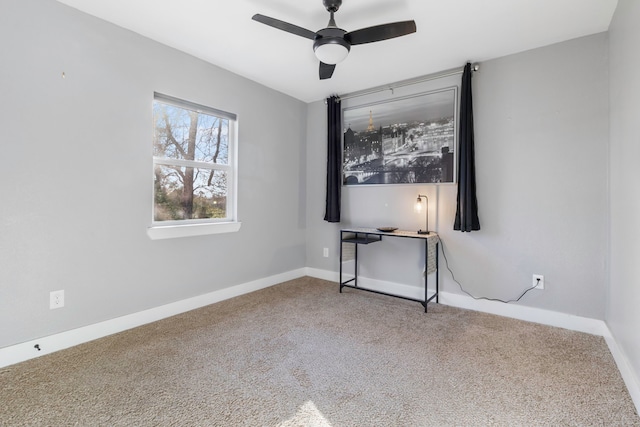 empty room with ceiling fan, carpet, and baseboards