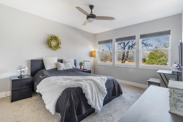 carpeted bedroom featuring ceiling fan and baseboards