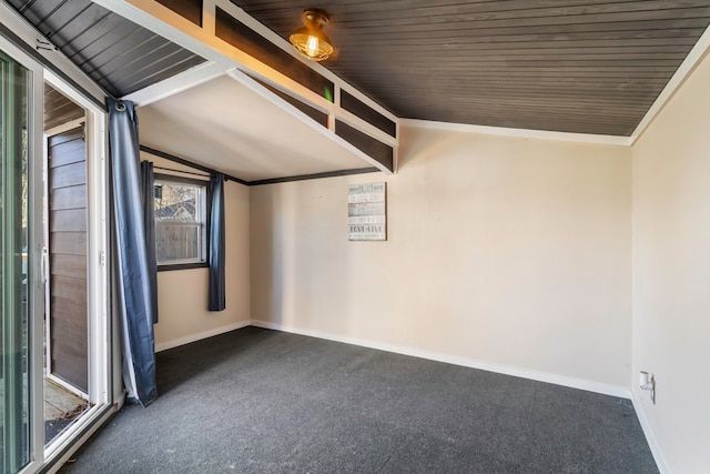 carpeted empty room with lofted ceiling, ornamental molding, and baseboards