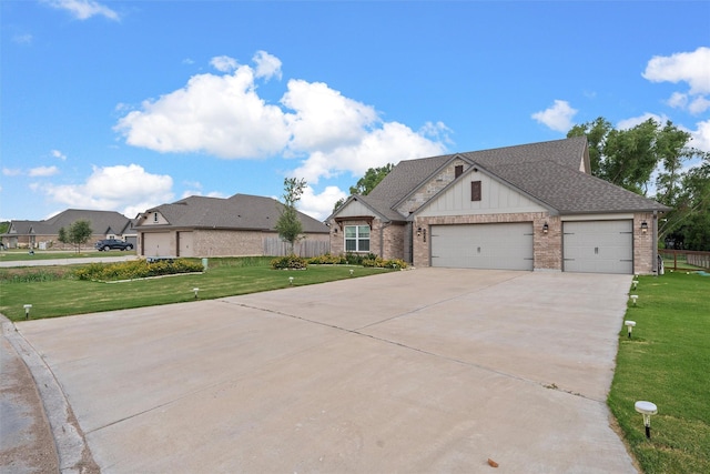 view of front of home featuring driveway, a front lawn, a shingled roof, a garage, and brick siding