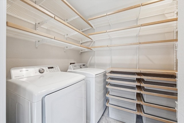 clothes washing area featuring laundry area and separate washer and dryer