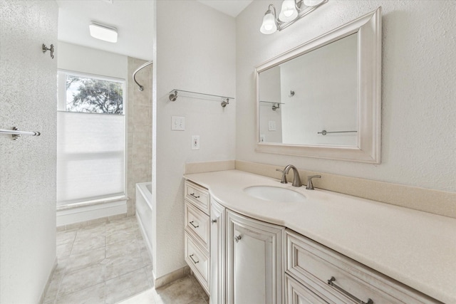 bathroom featuring tile patterned flooring, shower / bathing tub combination, and vanity