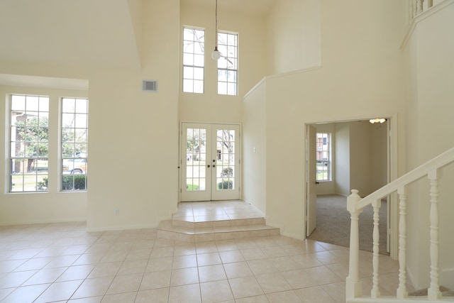 entryway featuring french doors, light tile patterned floors, visible vents, stairway, and baseboards