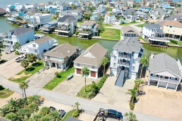 bird's eye view featuring a water view and a residential view