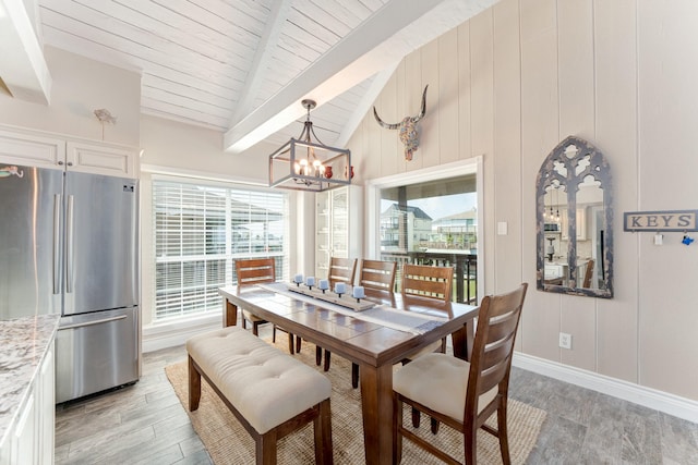 dining area featuring baseboards, lofted ceiling with beams, wooden ceiling, light wood-style flooring, and a notable chandelier