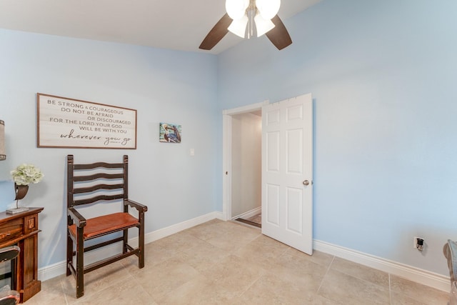 sitting room featuring ceiling fan and baseboards