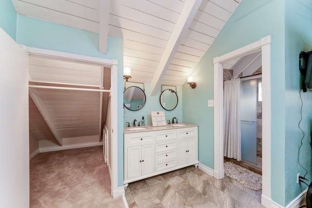 bathroom featuring vaulted ceiling with beams, curtained shower, a sink, and baseboards