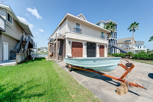 view of front of house with stairs and a front yard