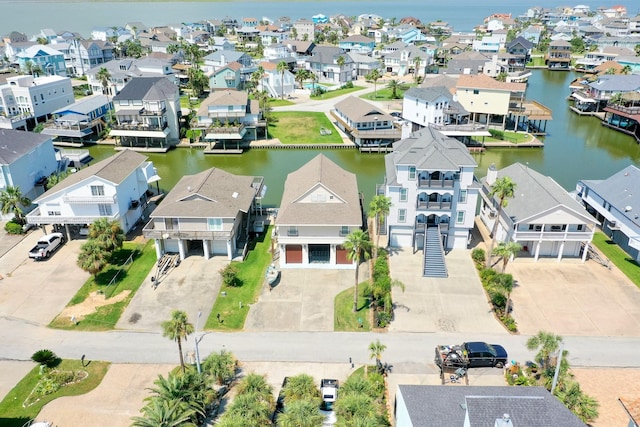 drone / aerial view with a water view and a residential view