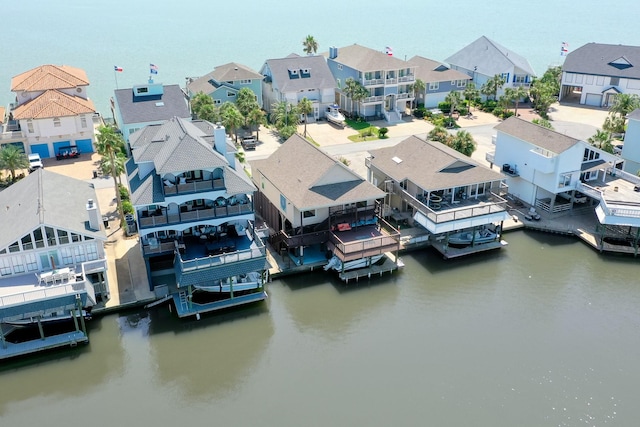 drone / aerial view with a water view and a residential view