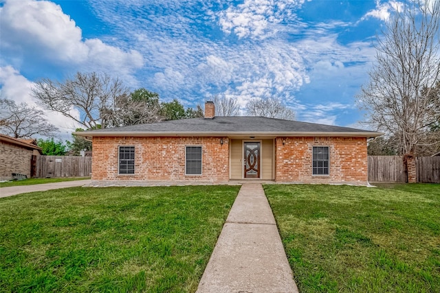 ranch-style home with brick siding, fence, a chimney, and a front lawn