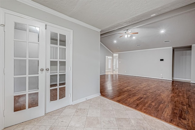 spare room featuring a textured ceiling, ornamental molding, lofted ceiling with beams, and light tile patterned flooring