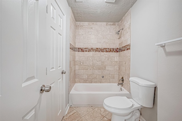 full bath featuring tile patterned flooring, tub / shower combination, a textured ceiling, and toilet