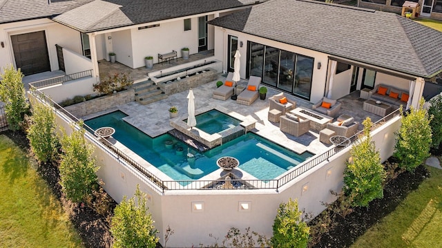 exterior space featuring a patio, a fenced backyard, an outdoor kitchen, and an outdoor living space with a fire pit