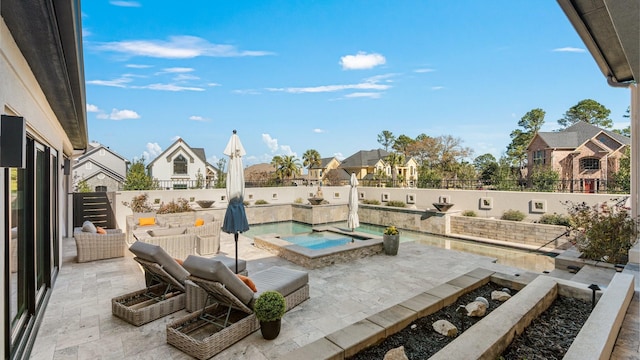 view of patio / terrace featuring a residential view, a fenced backyard, and an in ground hot tub