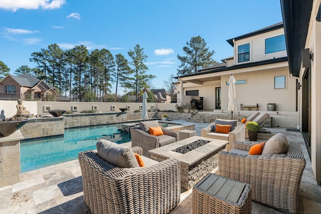 view of swimming pool featuring a patio area, fence, a fenced in pool, and an outdoor living space with a fire pit