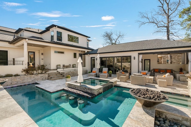 rear view of house featuring a patio area, stucco siding, outdoor lounge area, and an in ground hot tub