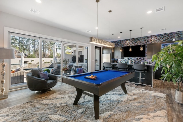 recreation room featuring bar, visible vents, recessed lighting, and wood finished floors