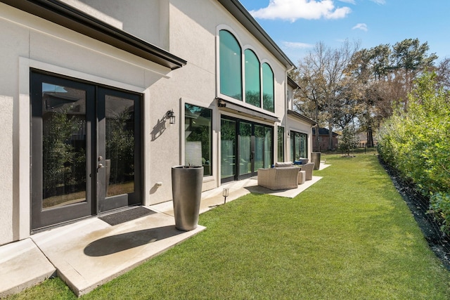 back of property with a patio, a yard, fence, french doors, and stucco siding