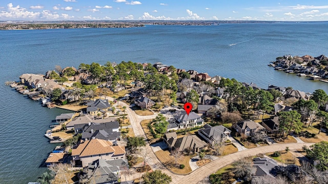 drone / aerial view with a water view and a residential view