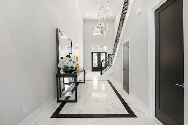 entrance foyer featuring baseboards, a towering ceiling, stairway, marble finish floor, and recessed lighting