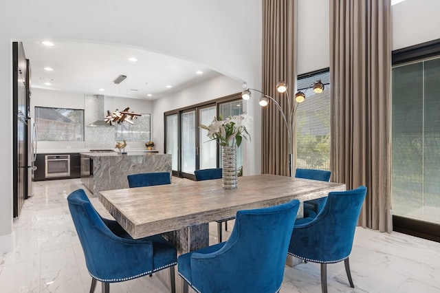 dining space with marble finish floor, arched walkways, and a wealth of natural light