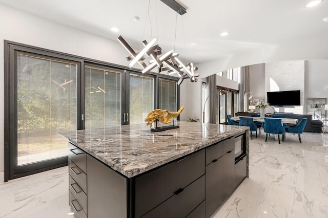 kitchen with a center island, marble finish floor, recessed lighting, and modern cabinets