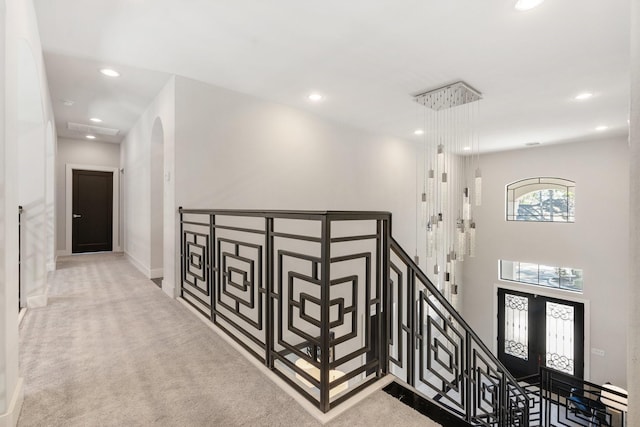 interior space featuring carpet floors, arched walkways, french doors, recessed lighting, and a high ceiling