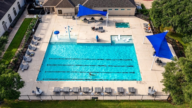 view of swimming pool with a patio area and fence