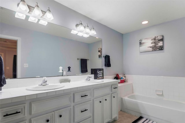 full bath featuring a bath, double vanity, and a sink