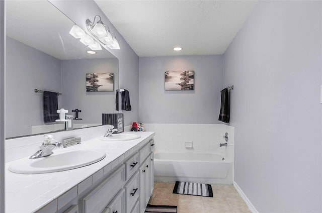 full bathroom with double vanity, a garden tub, tile patterned flooring, and a sink