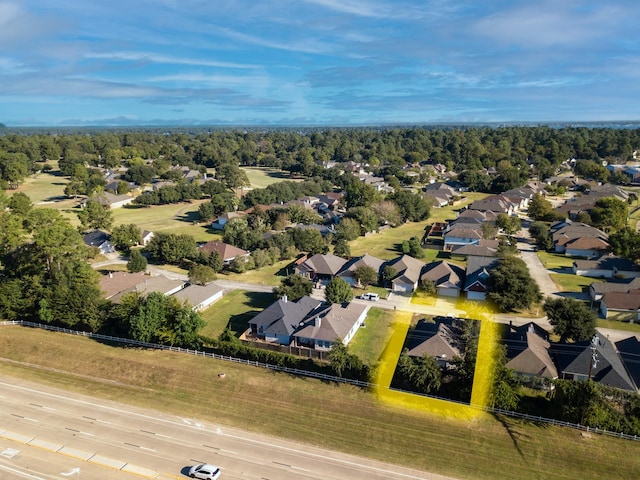 birds eye view of property with a forest view and a residential view