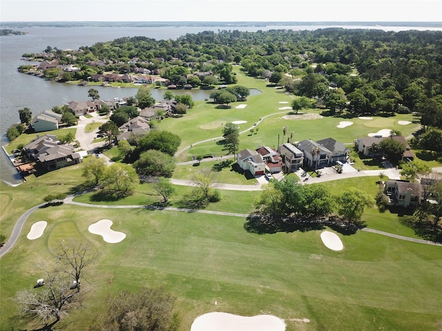 drone / aerial view featuring view of golf course, a water view, and a residential view