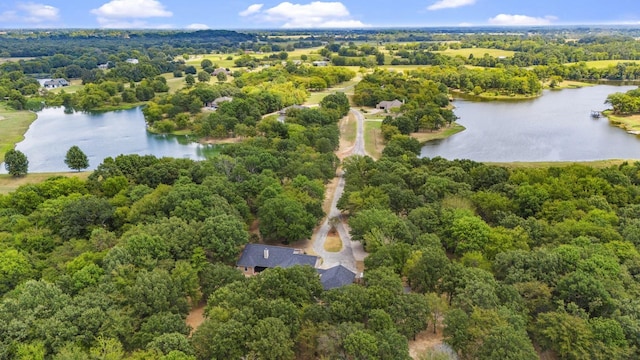 drone / aerial view featuring a water view and a view of trees