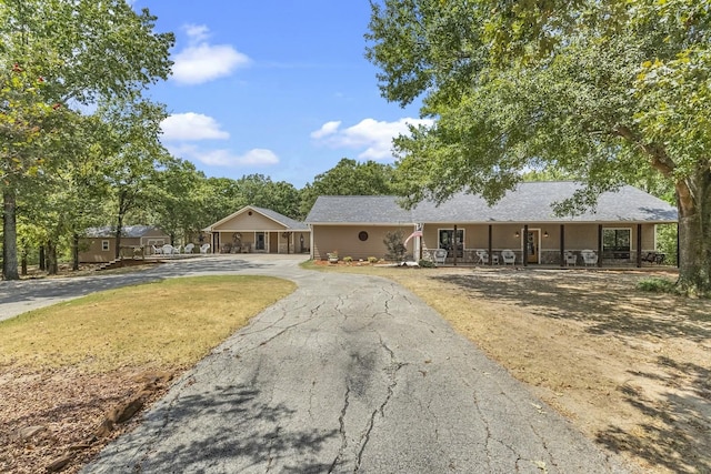 single story home featuring covered porch and driveway