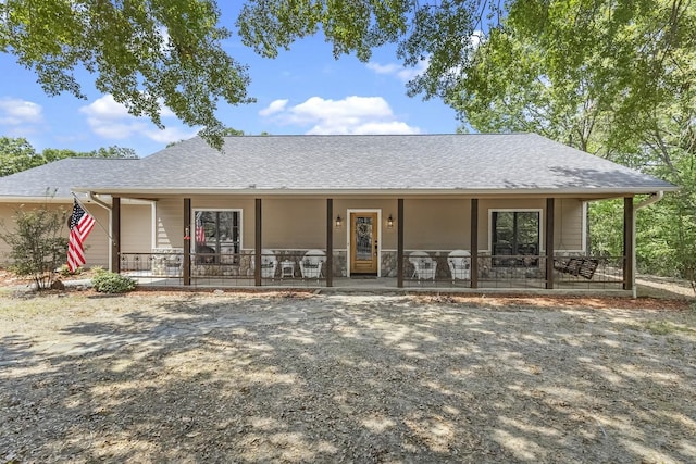 view of front of house featuring a porch and roof with shingles