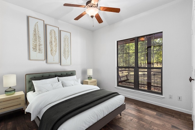 bedroom featuring ceiling fan, hardwood / wood-style floors, and baseboards