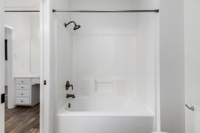 full bath featuring vanity, shower / bathtub combination, and wood finished floors