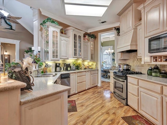 kitchen with crown molding, visible vents, stainless steel gas stove, a sink, and built in microwave