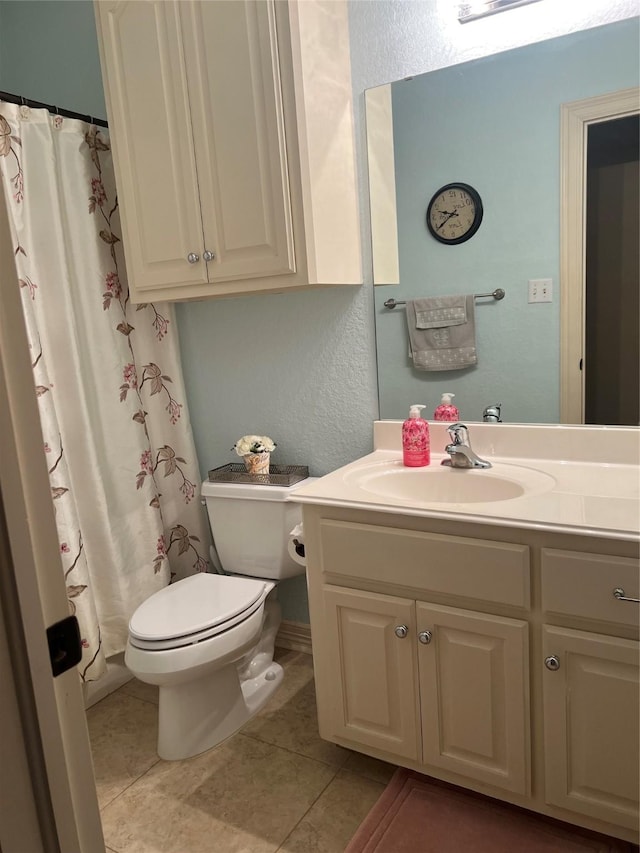 full bath featuring curtained shower, tile patterned flooring, vanity, and toilet