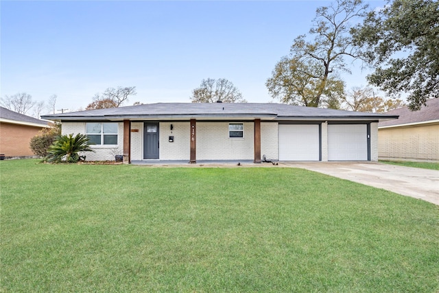 ranch-style home featuring driveway, a garage, a front lawn, and brick siding