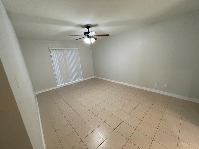 empty room featuring baseboards and a ceiling fan