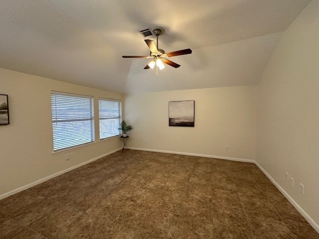 spare room featuring lofted ceiling, visible vents, ceiling fan, and baseboards