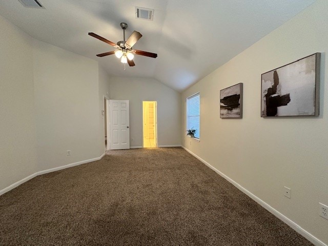 unfurnished bedroom featuring carpet, visible vents, vaulted ceiling, and baseboards