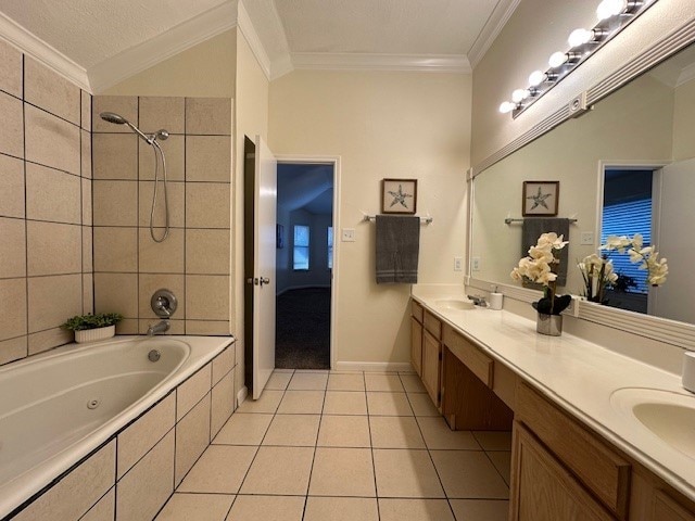 ensuite bathroom featuring double vanity, tile patterned flooring, tiled shower / bath, crown molding, and a sink